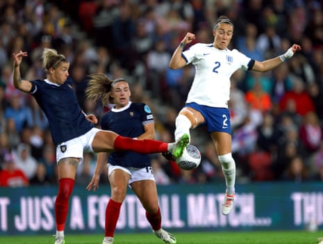Scotland's Nicola Docherty battles for the ball with England’s Lucy Bronze.