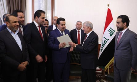 New Iraqi president Abdul Latif Rashid hands over the letter of assignment to form a new government to the nominated prime minister Mohammed Shia Al Sudani at the Iraqi Parliament in Baghdad, Iraq on 13 October 2022.