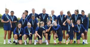 The Chelsea players pose with the Barclays FA Women’s Super League trophy and their winners medals ahead of a training session in August.