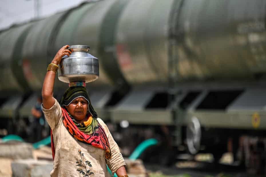 Indian woman carrying water pitcher on her head