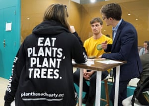 Joel Scott-Halkes (R), campaigns director at RePlanet, and Max Weiss (C), the plant-based treaty global campaigner, working at the summit.