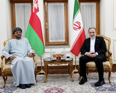 Iran's Araghchi and Oman's Albusaidi sit in ornate chairs beside national flags