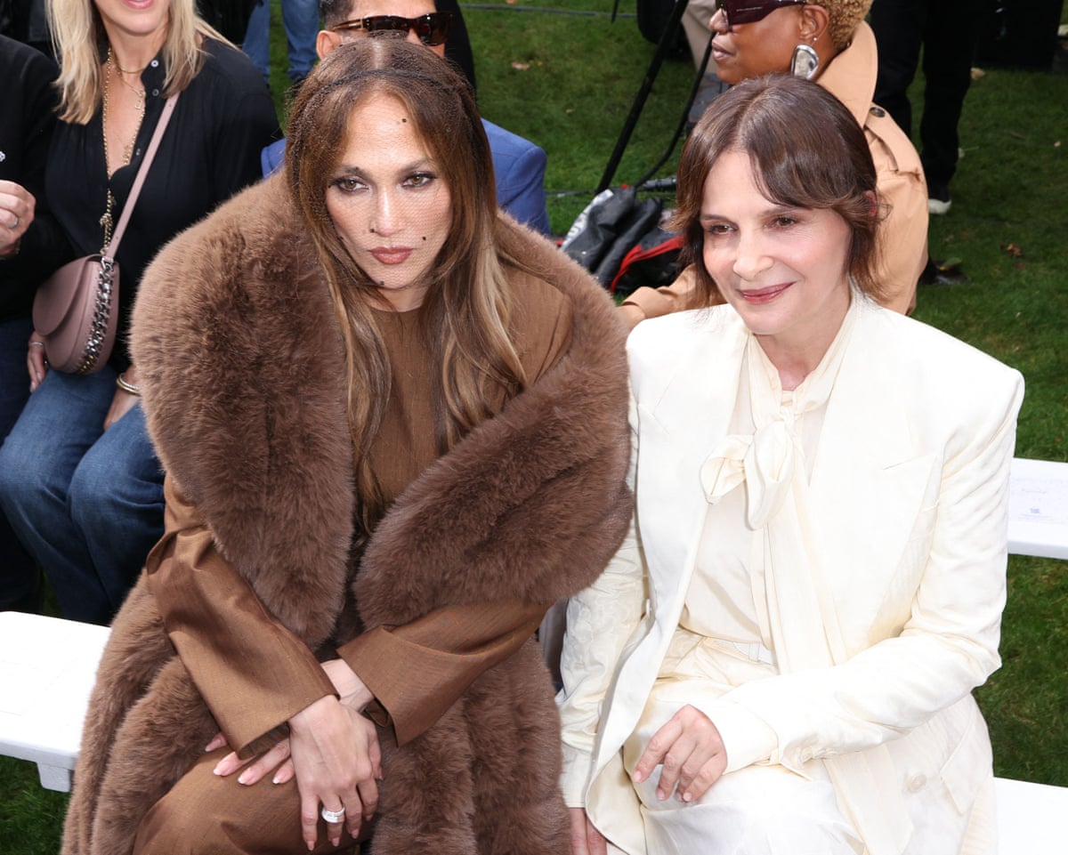Jennifer Lopez and Juliette Binoche pose for a photo from the front row of the show
