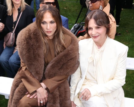 Jennifer Lopez and Juliette Binoche pose for a photo from the front row of the show