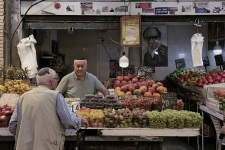 A man running a fruit stall