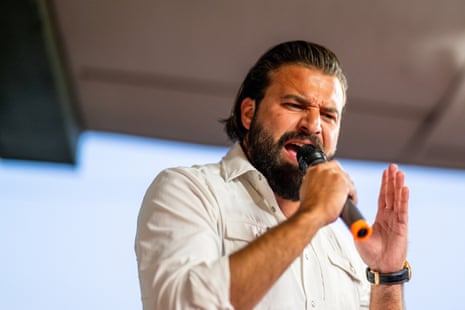a man shouts into a microphone