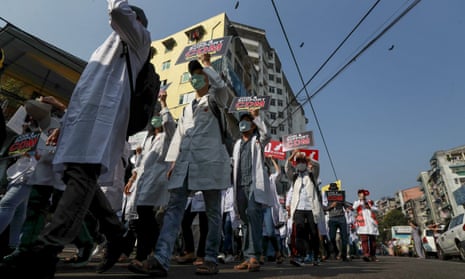 Doctors take part in an anti-coup march in Yangon in February