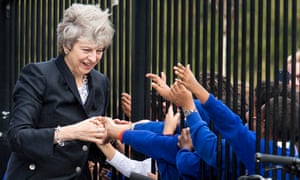 The prime minister, Theresa May, is greeted by pupils during a visit to the Dunraven school in Streatham, south London in 2017