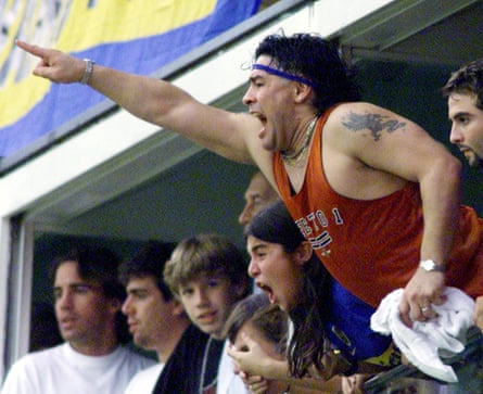 Diego Maradona cheers on Boca Juniors during a match against River Plate.