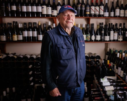 Roy Gillingham standing in front of shelves lined with bottles of wine