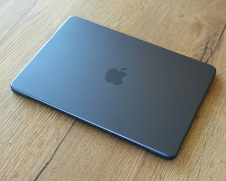 The lid of the Apple MacBook Neo in its midnight colour.