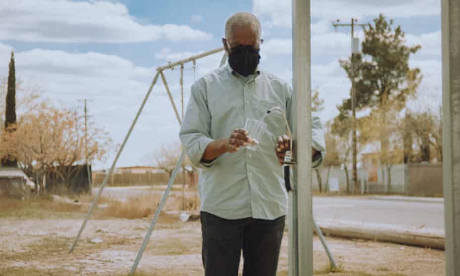 A man getting water from a Source hydropanel in Allensworth, California.