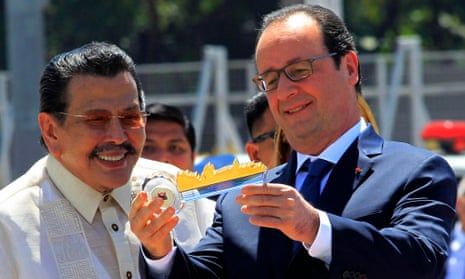 French President Francois Hollande (right) is promoting action on climate change during a visit to the Philippines.