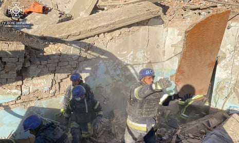 Rescuers clearing debris after reported Russian strike to lyceum building in Nikopol.