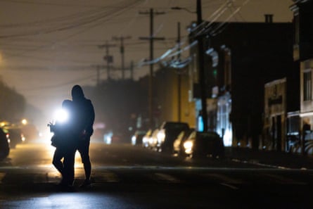 people cross a dark street