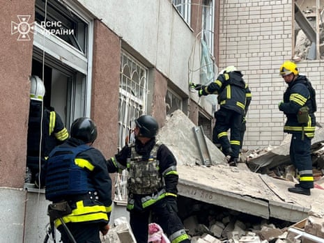 This image handout shows rescuers working at the site of a Russian missile strike in Chernihiv, Ukraine, on Wednesday.