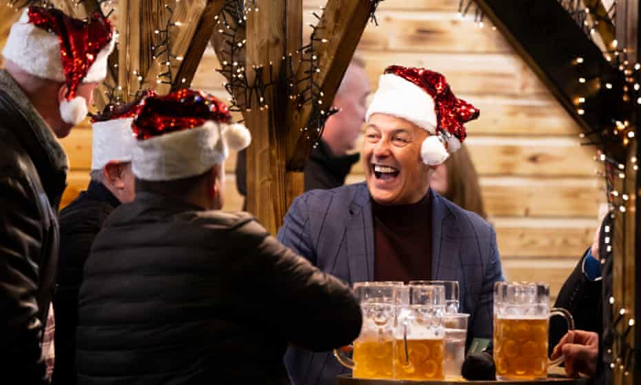 People drinking at an outdoor Christmas market in Cardiff