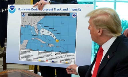 Donald Trump references a map while talking to reporters following a briefing from officials about Hurricane Dorian. The map was a forecast from 29 August 2019 and appears to have been altered by a black marker to extend the hurricane’s range to include Alabama.