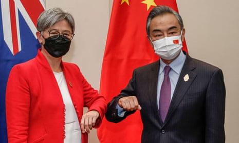 Australia's foreign affairs minister Penny Wong bumps elbows with her Chinese counterpart Wang Yi at the G20 in Bali in July. 