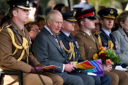 King Charles sat with men in military uniform