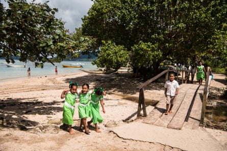 a group of girls walk together on Kioa