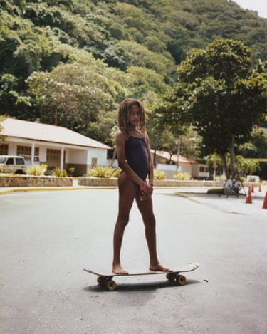 Los Caracas, 2022 . A girl on a skateboard stares into the camera