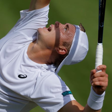 Felix Gill of Great Britain serves with the shadow of his racket over his face in his loss to Rafael Jodar of Spain.