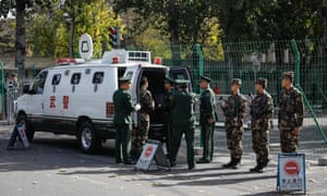 Chinese People’s Liberation Army soldiers stand guard near St Regis hotel, where Donald Trump is expected to stay during his visit to China.