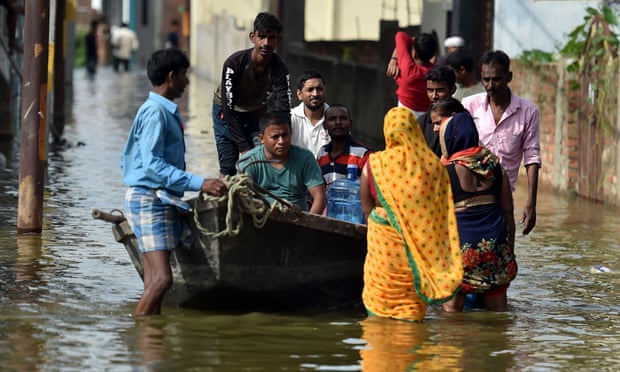 Residents wade through floodwater near the banks of the Ganges in Allahabad, India.