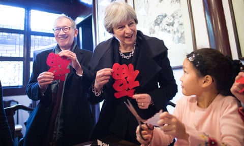 Theresa May and her husband, Philip, meet schoolchildren in Shanghai.