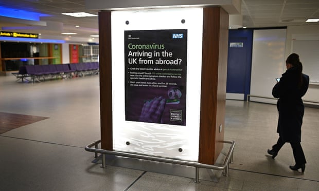 A UK government advert giving information about coronavirus at Manchester airport.