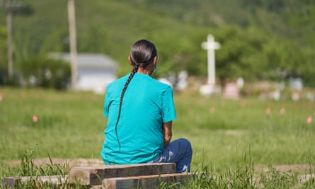 A man sits and prays at the field where the remains of over 750 children were buried on the site of the former Marieval Indian residential school in Cowessess First Nation, Saskatchewan, last month.