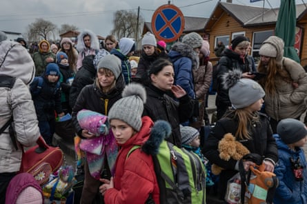 Refugees wait at the border crossing of Medyka after crossing into Poland.