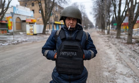 A city worker in protective gear on a street in Bakhmut.