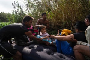 Asylum seekers get on an air mattress to cross the Rio Grande into Brownsville the day after Title 42 had been expected to be lifted but the decision has now been postponed until 27 December