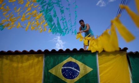 A man works to hang up street decorations in Brasília