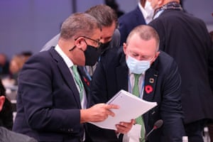 Alok Sharma (left) and Lee White, Gabon’s environment minister, pore over the document