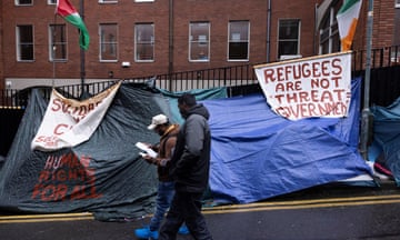 Asylum seekers outside the International Protection Office, in Dublin.
