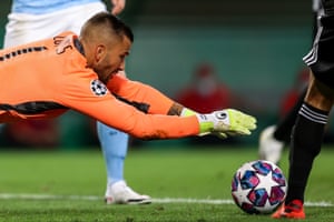 Lyon keeper Anthony Lopes pounces on the ball.