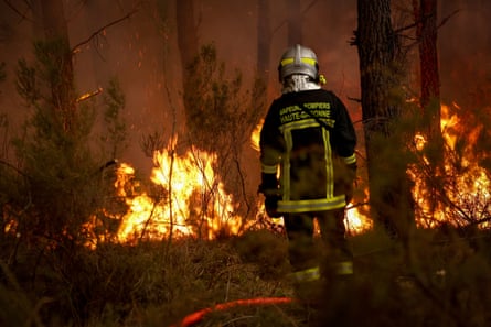 A firefighter watches the flames of a forest fire in Saint-Jean-d'Illac near Bordeaux.