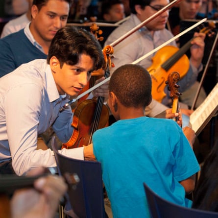 Musicians from the Simón Bolívar Youth Orchestra play with Stockwell Children’s Orchestra in 2012.