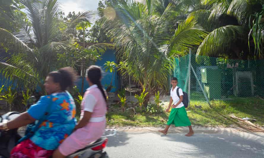 A young boy walks home from school in the Tuvaluan capital of Funafuti.