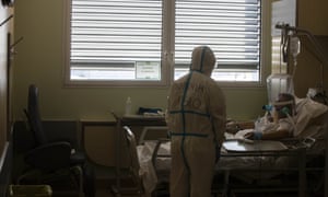 Deputy head of the intensive care unit Flavio Tangian talks with a Covid-19 patient at the Circolo hospital, in Varese, Italy, in May.