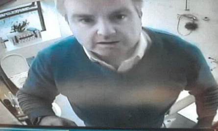 Holden adjusting a hidden camera in a bathroom