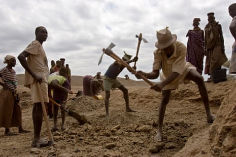 Local Turkana men and women from Kanukurudio dig a new water pan in Northern Kenya.