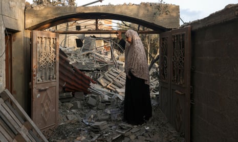 A woman inspects the damage to her home after Israeli strikes on the Rafah camp in the southern Gaza Strip
