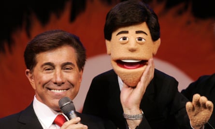 Steve Wynn stands next to puppet made to look like him at a news conference in Las Vegas
