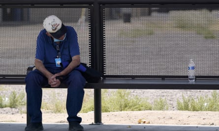 A person found a welcome bit of shade at a bus stop in Phoenix, June 2021.