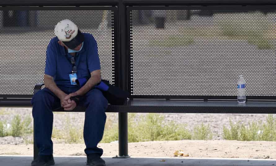 A person found some shade at a bus stop in Phoenix, June 2021.