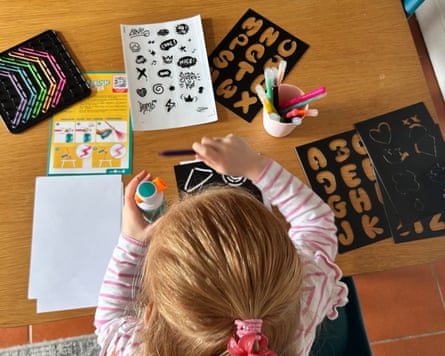 A girl plays with Airbrush art set